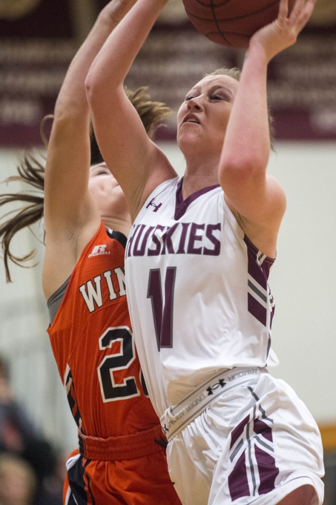 Maine Central Institute's April McAlpine (11) draws a foul from Winslow defender Bodhi Littlefield during a game in Pittsfield last week.