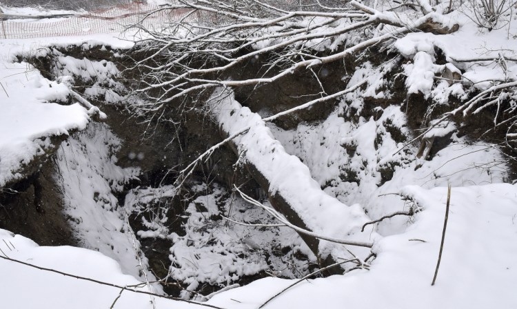 A large sinkhole off Halifax Street in Winslow exposed a 24-inch sewer line, center, and drain lines. Workers with the Ted Berry Co., of Livermore, on Wednesday built a bypass line so that sewer service would continue uninterrupted and permanent repairs could be made.