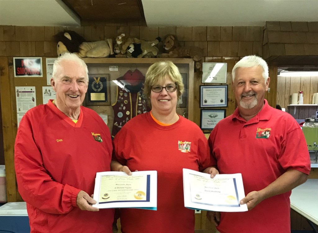 Lion Don Taylor, left, Past President Deb Maddox and Lion David Worthing.