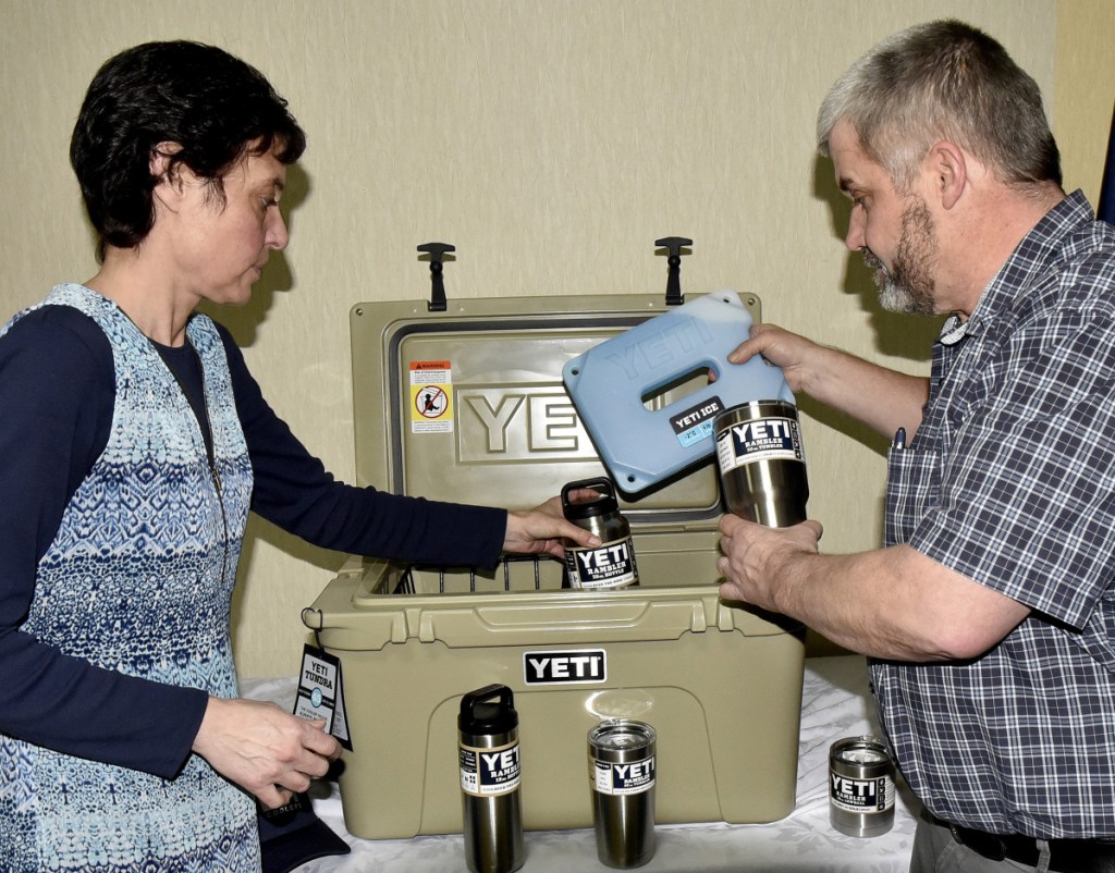 Angela Derosby and Bob Marin fill a Yeti cooler with other products that make up a door prize for entrants of the 20th annual Gene and Lucille Letourneau Ice Fishing Derby, scheduled for Feb. 18.