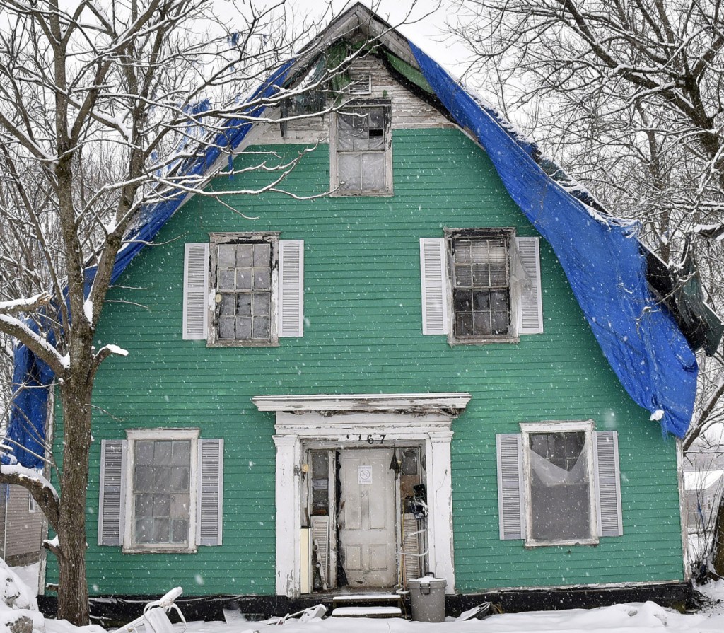 Charles McIntyre's house on Main Street in Clinton, seen Wednesday, has been in what the town calls a state of disrepair for decades and will be the subject of a meeting by the town to determine a course of action.