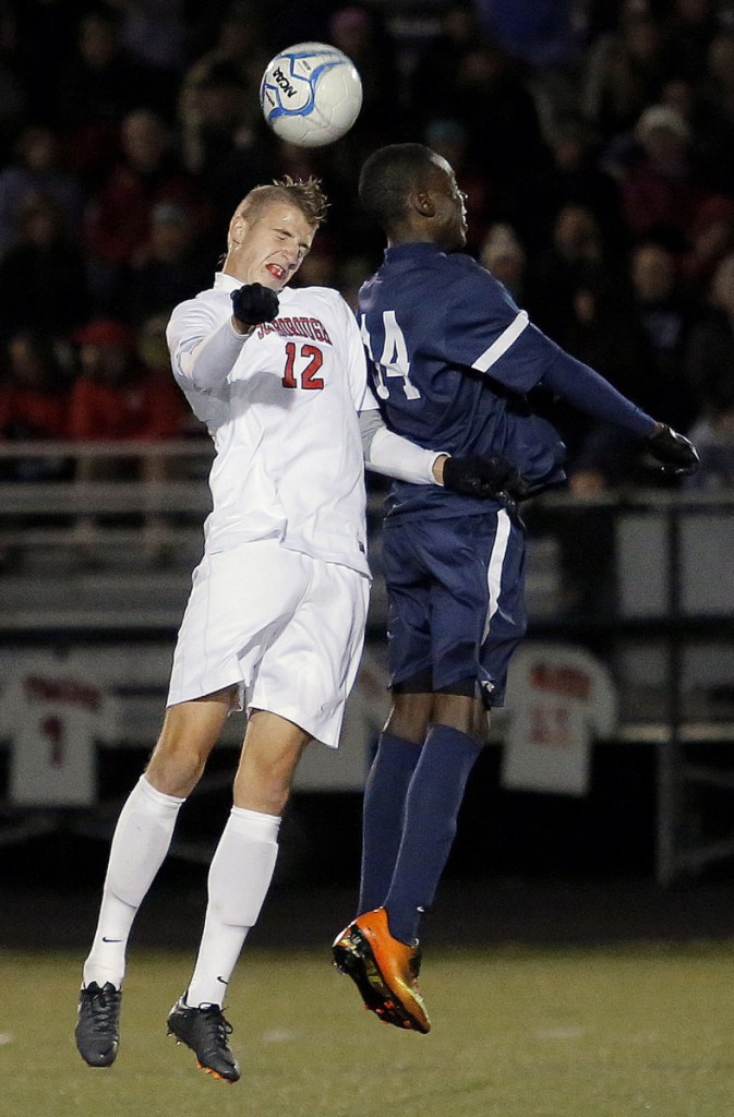 Scarborough's Wyatt Omsberg, left, challenges Portland's Jonathan Bobe for possession of the ball during the 2013 Western Class A soccer final in Scarborough.