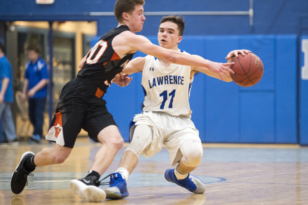 Staff photo by Michael G. Seamans 
 Lawrence's Kobe Nadeau (11) nearly has the ball stolen by Winslow's Isaiah Goldsmith in the first half Saturday in Fairfield.