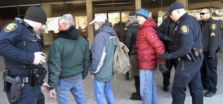 Augusta Police arrest protesters Monday at Central Maine Power in Augusta. Four people from the group Speak The Truth to CMP "volunteered" to be detained by police after refusing to disperse during a protest to raise awareness about CMP's opposition to net metering, protesters said.