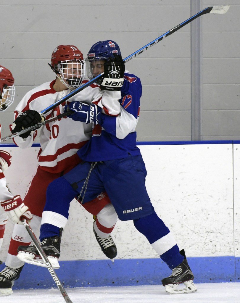 Cony's Michael Boivin, left, collides with Lisbon/Mt. Ararat/Morse's Cam Poisson during a Class A North game Tuesday in Hallowell.