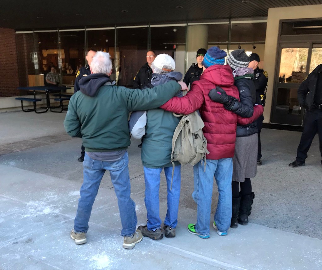 Four protesters willfully getting arrested at Central Maine Power protests on Monday. 