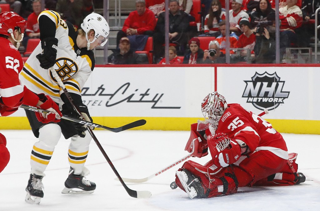 Detroit goaltender Jimmy Howard stops a shot by Boston's Danton Heinen during the third period of Tuesday's in Detroit. Boston won 3-2.