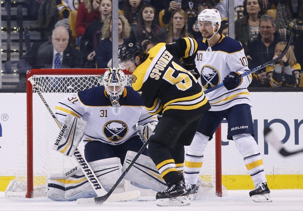 Ryan Spooner of the Bruins looks for an opening against Sabres goalie Chad Johnson during Buffalo's 4-2 win Saturday night in Boston.