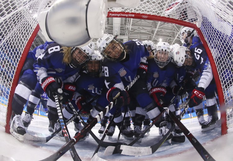 Players from the United States pose fas they gather around the goal before their women's hockey game against the team from Russia at the 2018 Winter Olympics on Tuesday. ()