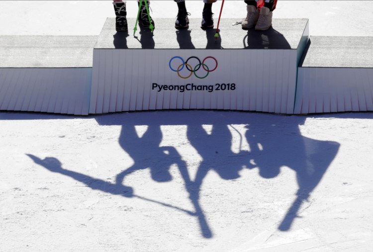 Austria's Anna Veith, silver, Czech Republic's Ester Ledecka, gold, and Liechtenstein's Tina Weirather, bronze, from left, celebrate during the venue ceremony for the women's super-G.