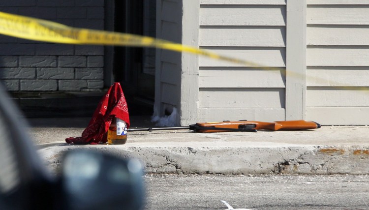 A pellet rifle and a bandanna-covered bottle of malt liquor remain at the strip mall in Portland after Chance Baker, 22, was shot by police last year.