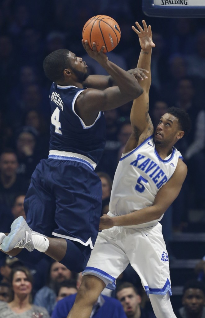 Villanova forward Eric Paschall shoots against Xavier guard Trevon Bluiett during the first half of the Wildcats' 95-79 victory at Cincinnati on Saturday.