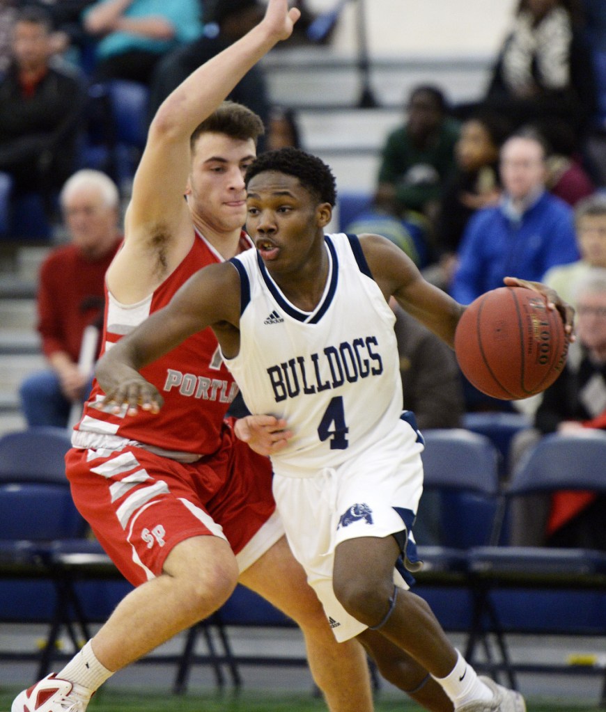 Portland's Terion Moss drives to the basket as South Portland's Noah Malone plays defense in a game on Jan. 11. (Staff photo by Shawn Patrick Ouellette/Staff Photographer)