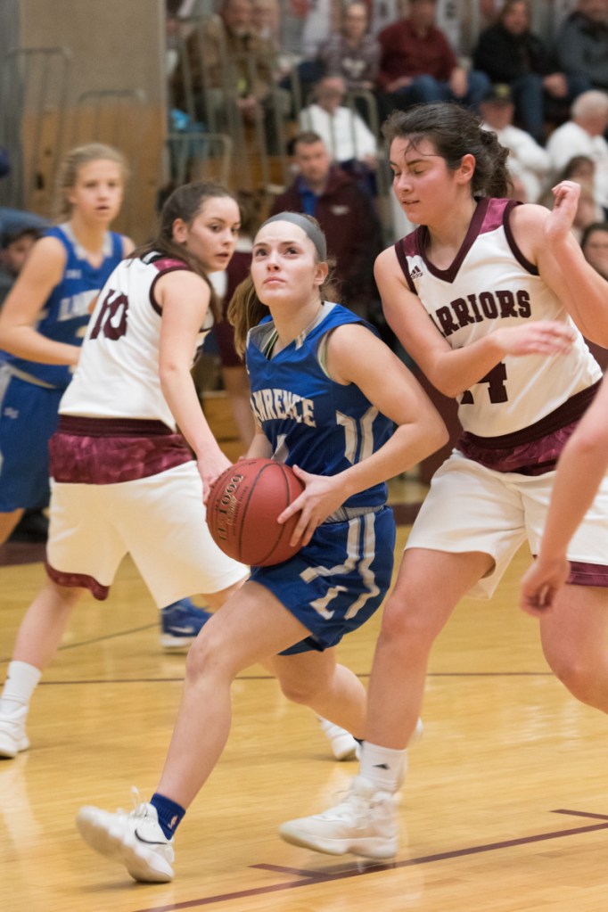 Lawrence sophomore Megan Curtis sophmore goes in for a layup as Nokomis senior Chelsea Crockett defends during a Kennebec Valley Athletic Conference Class A game Tuesday night in Newport.