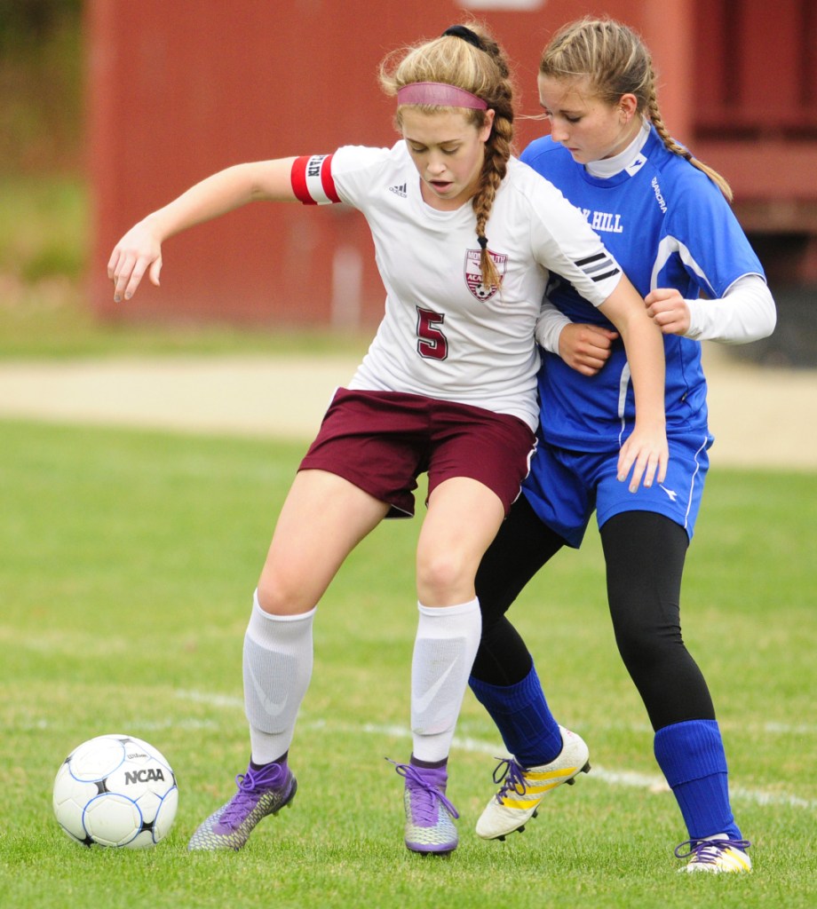 Monmouth midfielder Emily Grandahl, left, looks to fend off Oak Hill's Charlotte Waterman during a 2016 Mountain Valley Conference game in Monmouth.