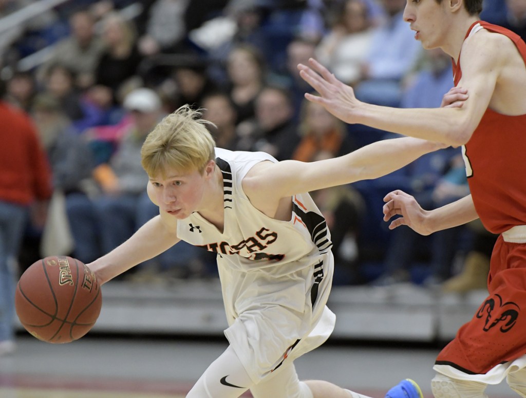 Cony's Austin Parlin, right, can't slow Gardiner's Kyle Johnson during a Kennebec Valley Athletic Conference Class A game earlier this season at the Augusta Civic Center.