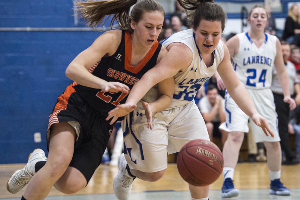 Skowhegan's Annie Cooke, left, battles for the loose ball with Lawrence's Haley Holt in a Class A North game Thursday in Fairfield.