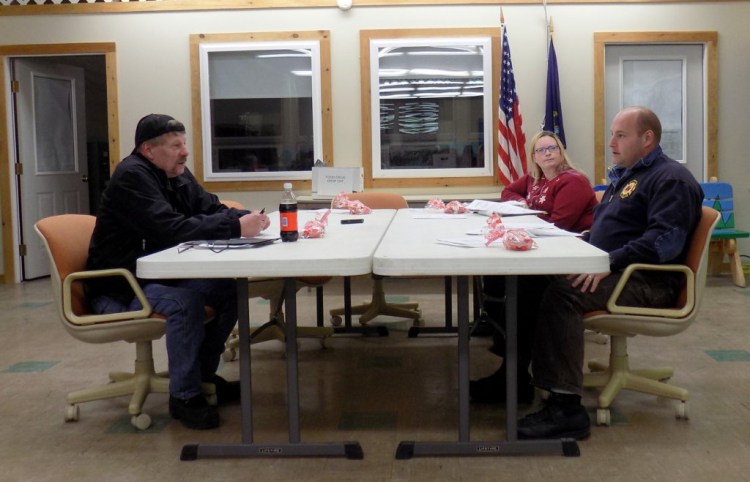 Selectmen Matt Welch, left, Tiffany Estabrook and Edward Hastings IV discuss town warrant articles on liquor sales and a land use ordinance during Thursday night's public hearing in Chesterville.