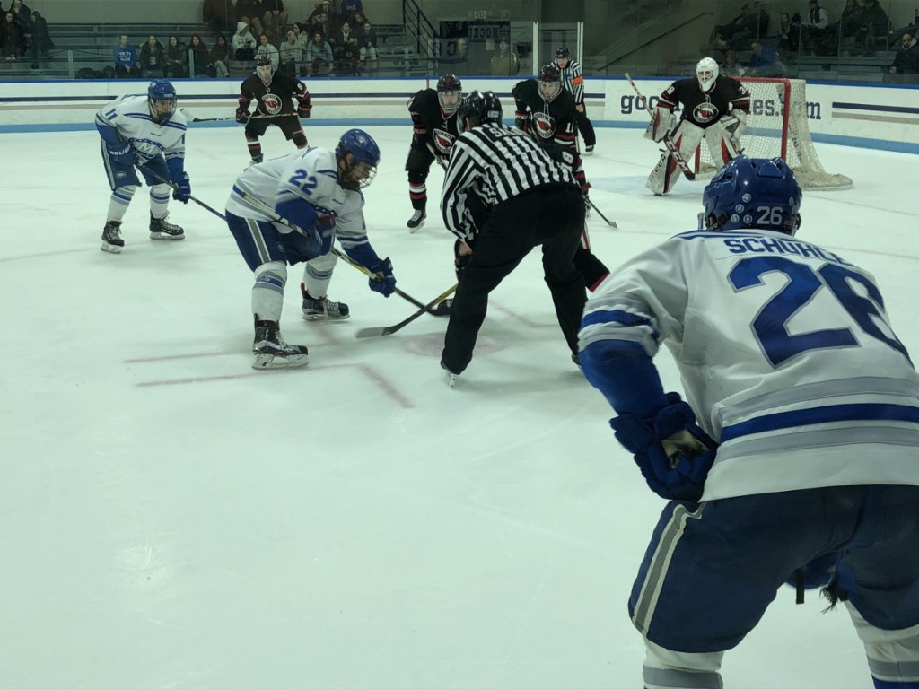 Staff photo by Travis Barrett 
 Colby's Nick O'Connor (22) gets ready to take a faceoff in the third period against Wesleyan as teammate J.P. Schuhlen (26) looks on Sunday at Alfond Rink.