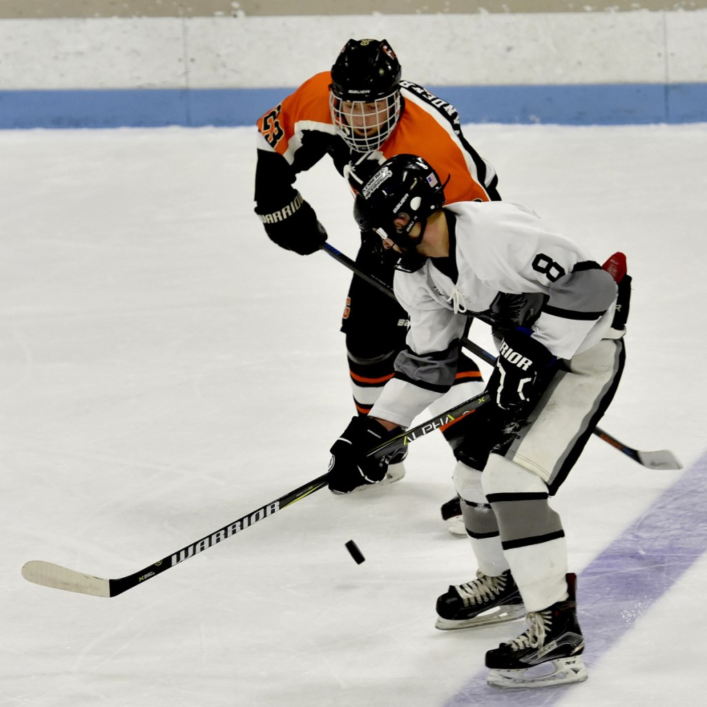 Staff photo by David Leaming 
 Kennebec's Cody Pellerin and Gardiner'sCasey Vandenbossche battle for the puck during a game Monday at Colby College.