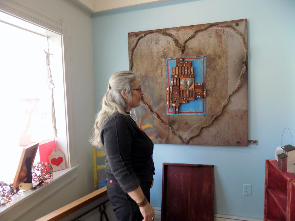 Vera Johnson, who has opened Vera's Iron and Vine on Front Street in Farmington, stands beside a piece she crafted using materials she found in an old East Dixfield barn.