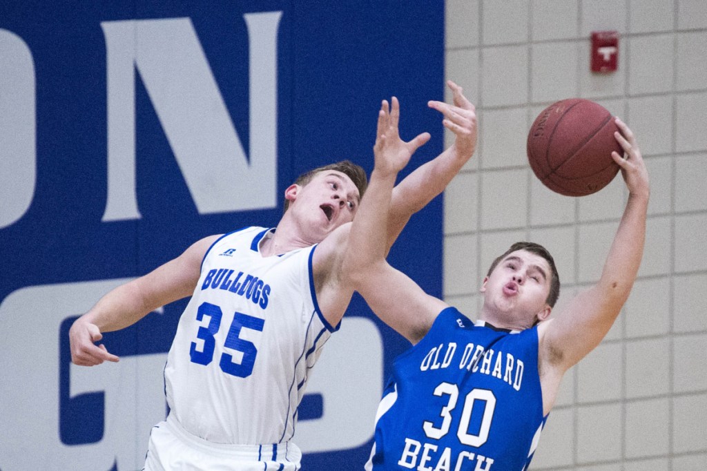 Madison's Max Shibley (35) battles for the rebound with Old Orchard Beach's Kyle Allen (30) in a Class C South preliminary game Wednesday in Madison.