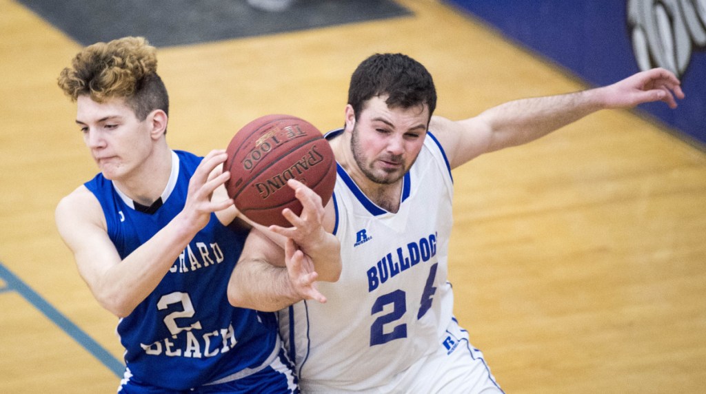 Old Orchard Beach's Dale Lord (2) battles for the rebound with Madison's Matt Oliver (24) in a Class C South preliminary game Wednesday in Madison.