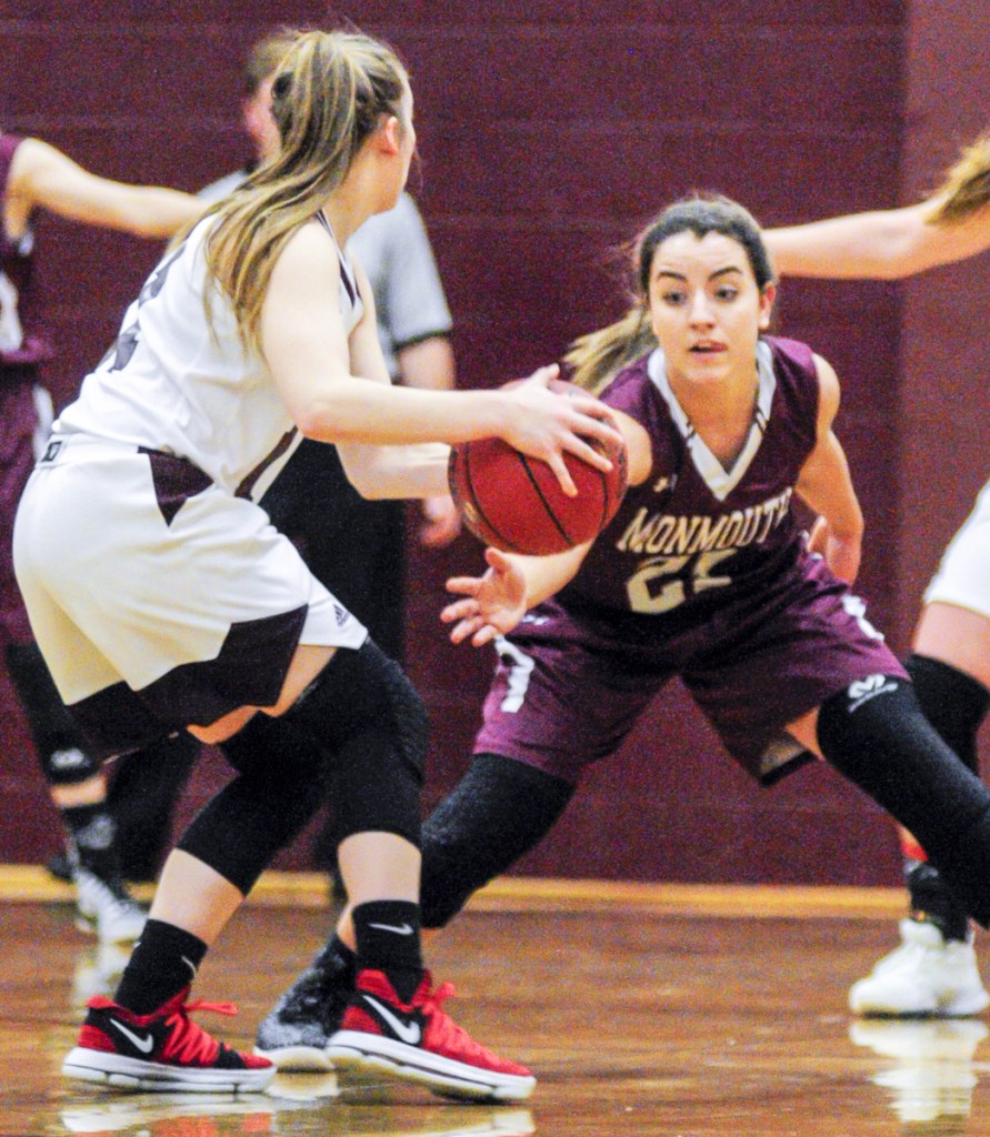 Richmond's Ashley Abbott, left, looks for a teammate to pass to as Monmouth's Abby Ferland defends during a Mountain Valley Conference game this season in Richmond.