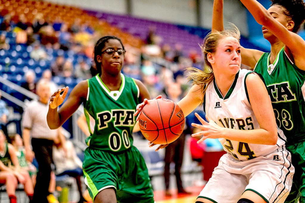 Rangeley's Natasha Haley looks for some space as Pine Tree Academy's Agnes Miongo, right, and Regence Sandy defend during a Class D South quarterfinal game Monday at the Augusta Civic Center.