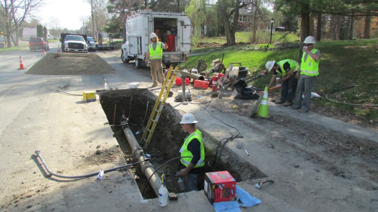 Employees from ETTI, a utilities construction company, replace an electrofusion tee on a Summit Natural Gas line in May 2015 in Waterville. Summit Natural Gas expects to invest at least $4.5 million in a new project to expand its services to Sidney.