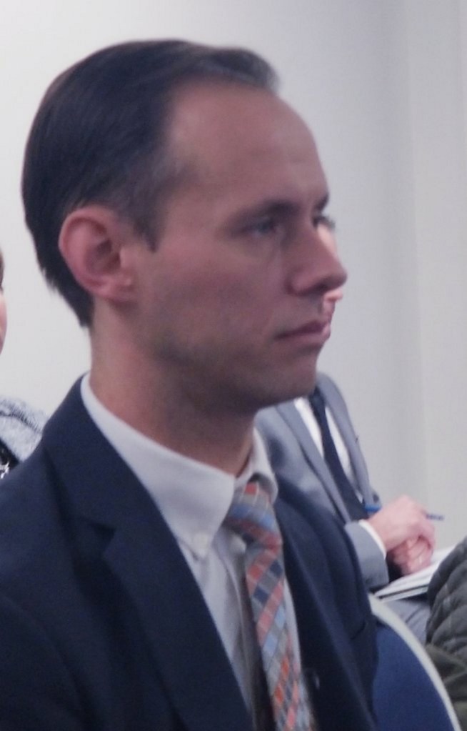 Maine Republican Party Executive Director Jason Savage listens to testimony Thursday at the Maine Ethics Commission.