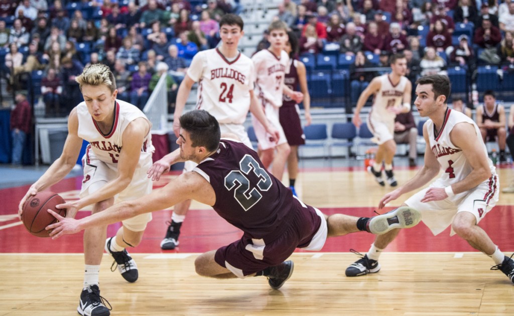 Richmond guard Zach Small (23) fouls Hall-Dale's Jett Boyer during a Class C South semifinal game Thursday at the Augusta Civic Center.