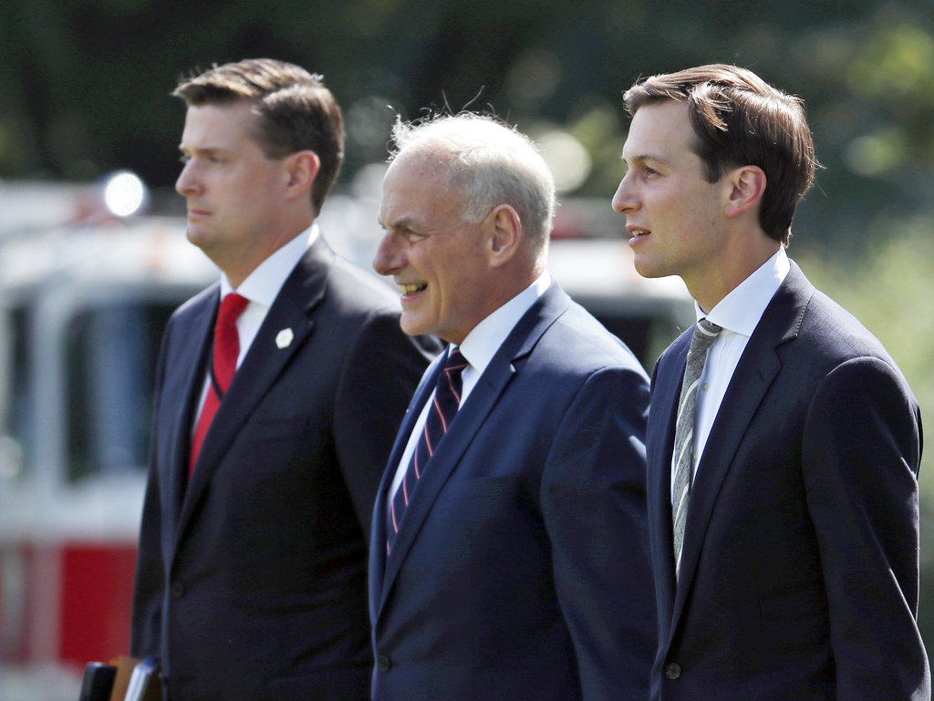 Then-White House staff secretary Rob Porter, left, White House Chief of Staff John Kelly, and White House senior adviser Jared Kushner walk to Marine One on the South Lawn of the White House on Aug. 4, 2017. 