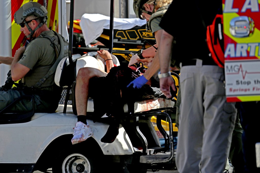 Medical personnel tend to a victim following a shooting at Marjory Stoneman Douglas High School in Parkland, Fla., on Wednesday, Feb. 14, 2018. 