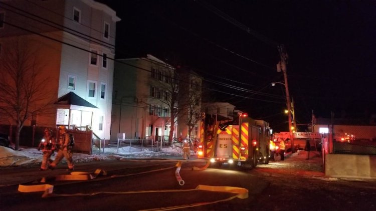 Lewiston firefighters work to douse flames at 242 Park St. early Sunday.