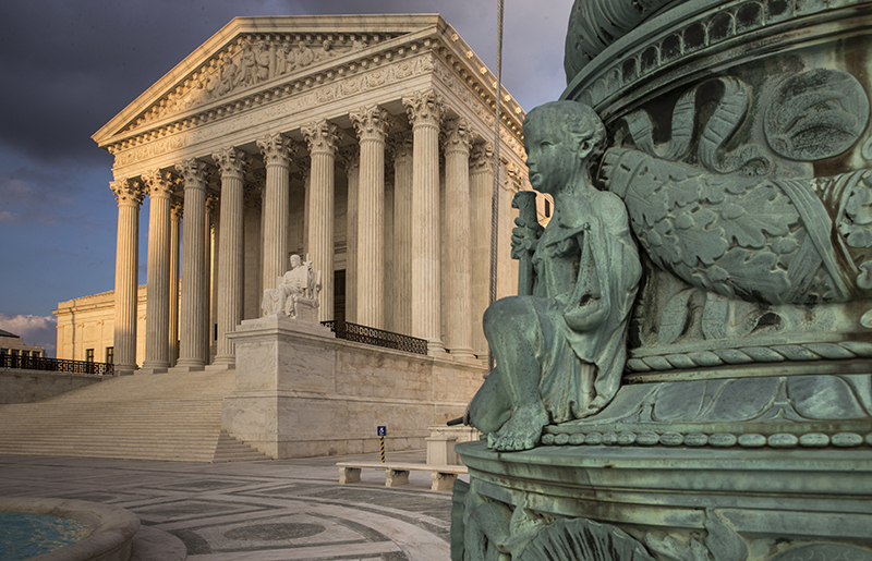 FILE - In this Oct. 10, 2017, file photo, the Supreme Court in Washington, at sunset. America's labor unions are about to find out if they were right about Justice Neil Gorsuch. In opposing Gorsuch's nomination to the high court last year, labor leaders said Gorsuch would vote against working people and for monied interests. The newest justice holds the deciding vote in a case to be argued Feb. 26 that is likely to affect the financial viability of unions that represent government workers. (AP Photo/J. Scott Applewhite, File)