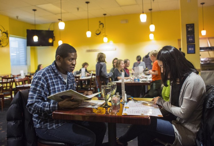 Tre Higgins of Williamsport, Pa., and Sun Park of Biddeford study their menus.