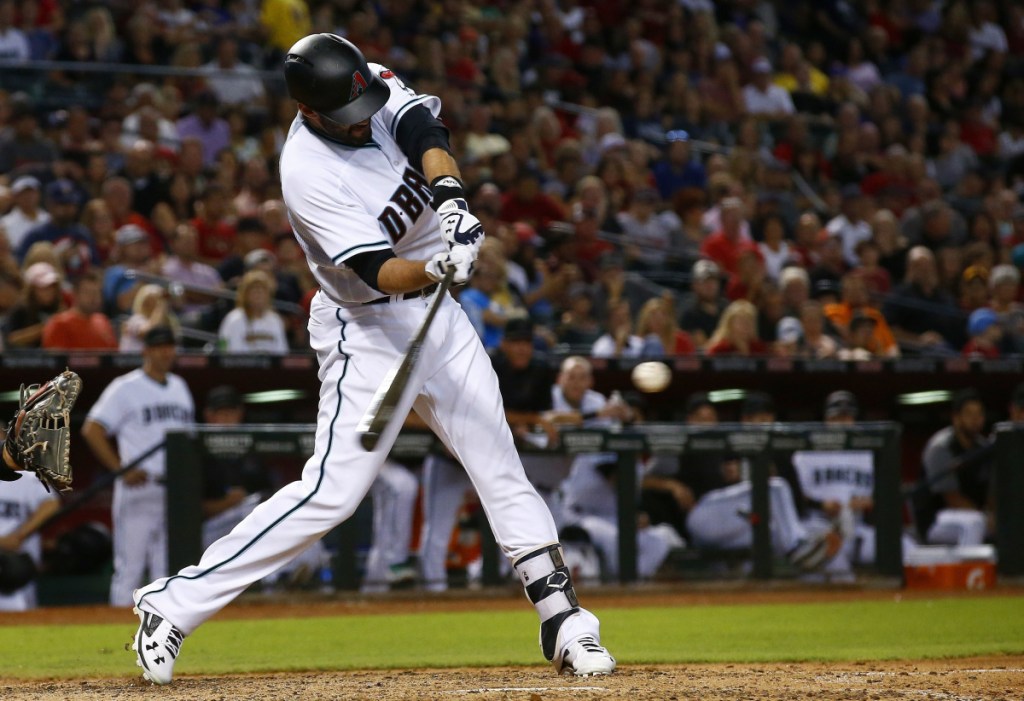 Arizona Diamondbacks' J.D. Martinez connects for a two-run home run against the San Diego Padres during the sixth inning of a baseball game Friday, Sept. 8, 2017, in Phoenix. ()