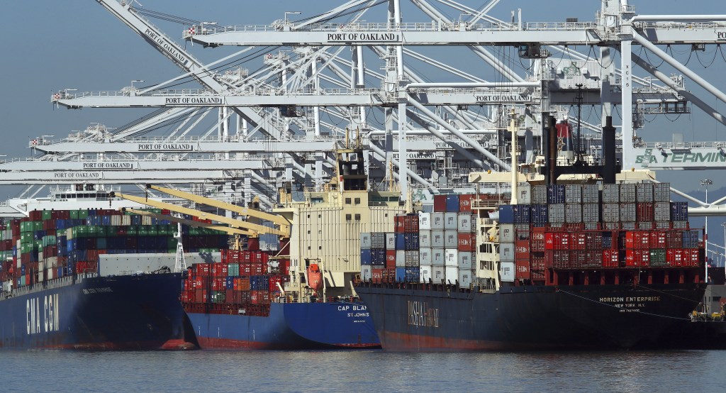 Container ships wait to unload their overseas cargo at the Port of Oakland. The White House is expected to make a final decision on new tariffs, which could have a significant impact on both imports and exports.