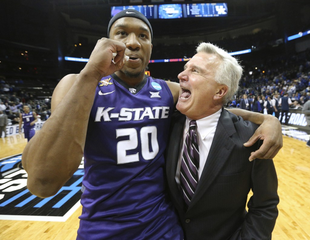 Kansas State Coach Bruce Weber and forward Xavier Sneed celebrate a 61-58 win over Kentucky in an NCAA men's basketball tournament late Thursday night.