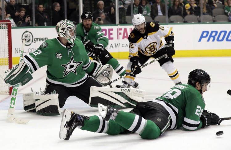 Dallas Stars defenseman Stephen Johns lays down to block a shot as goalie Kari Lehtonen, defenseman Marc Methot (33) and Boston's Brian Gionta (12) watch in the second period of the Bruins' 3-2 win Friday in Dallas.