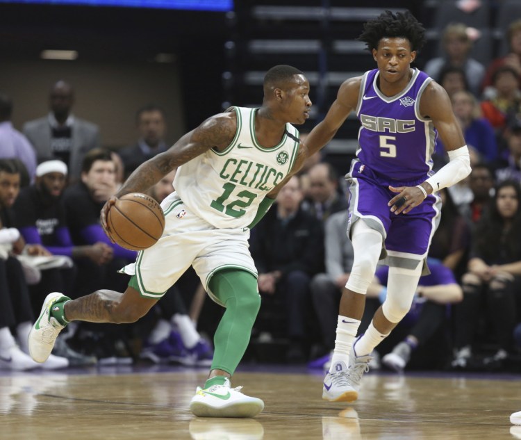 Celtics guard Terry Rozier drives around Kings guard De'Aaron Fox during Boston's 104-93 win Sunday in Sacramento, California.