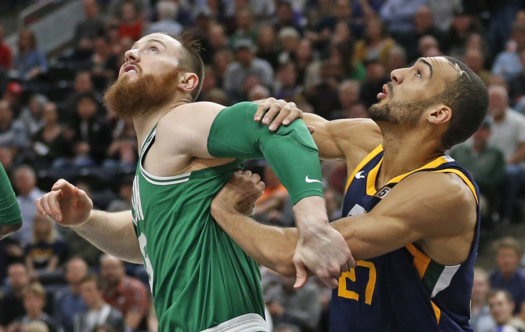 Boston center Aron Baynes and Utah center Rudy Gobert battle under the boards for a rebound Wednesday night in Salt Lake City.