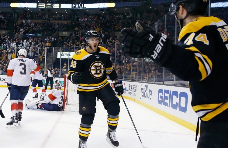 Boston's Jake DeBrusk, right, celebrates his goal with Kevan Miller during the second period of Saturday's game against the Florida Panthers in Boston. The Bruins won, 5-1.