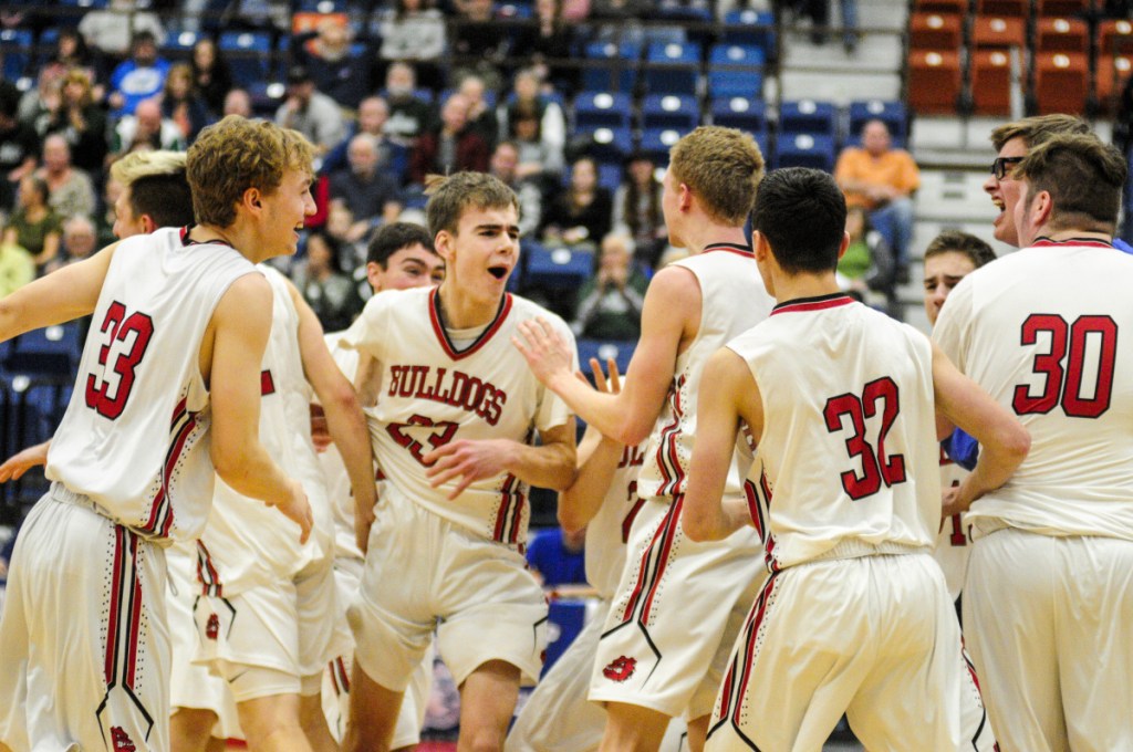 The Hall-Dale boys basketball team celebrates after it won the Class C South championship Saturday at the Augusta Civic Center.