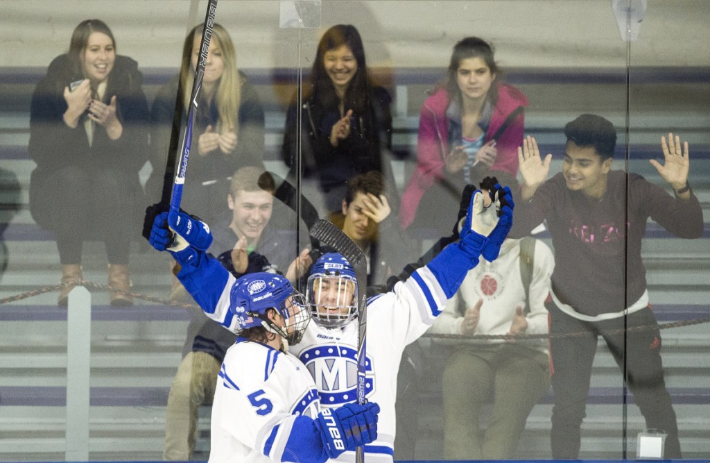 Colby College's Cam MacDonald celebrates a goal with teammate Dan Dupont (5) during a game earlier this season at Alfond Rink in Waterville. The Mules beat Wesleyan 5-1 in the NESCAC semifinals Saturday.