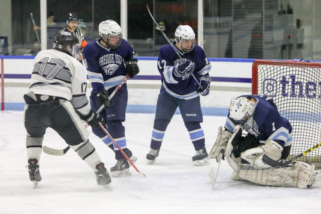 Kennebec's Cooper Hart (17) takes a shot on Presque Isle goalie Andre Daigle during a Class B North semifinal game Saturday at Colby College.