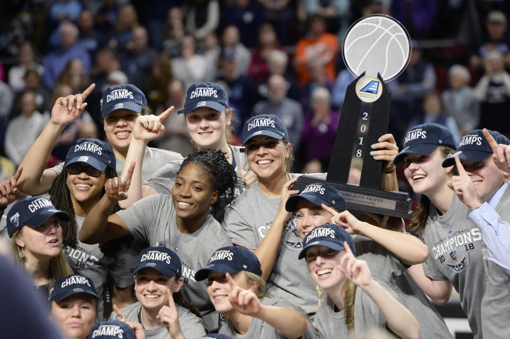 The University of Maine women's basketball team celebrates after winning the America East championship over Hartford on Friday in Bangor.