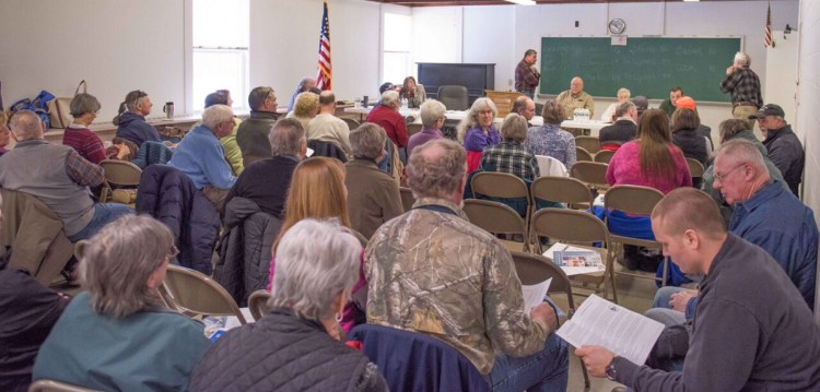 Rome residents gather for Saturday's Town Meeting, where a referendum about appropriating money to repave and reconstruct North Pond Road passed overwhelmingly.