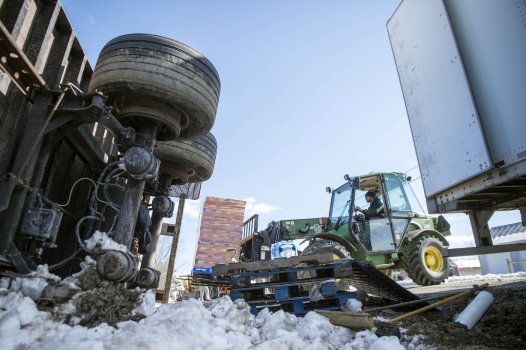 A tractor was employed to transfer a payload of beer from one tractor-trailer to another Friday after the first rolled over on Trafton Road in Waterville when it hit a soft shoulder.